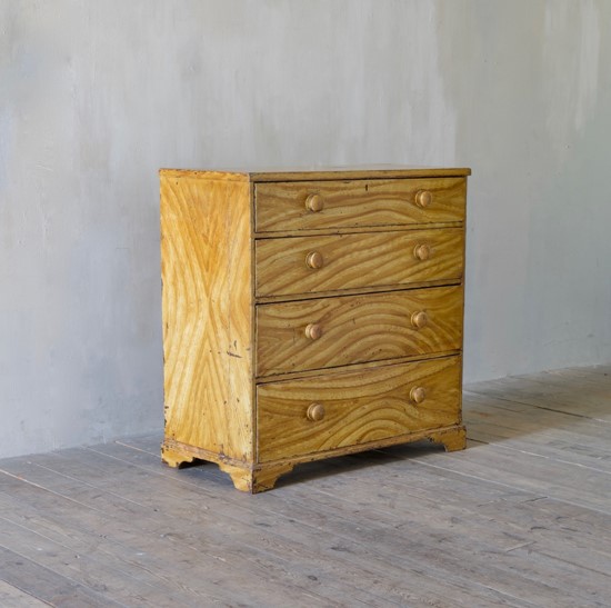 A faux elm painted chest of drawers