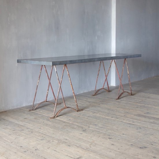 An architectural wrought iron trestle table