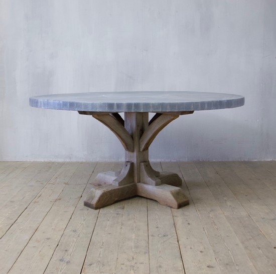 A weathered oak and zinc dining table