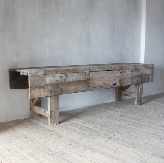 A large weathered work table