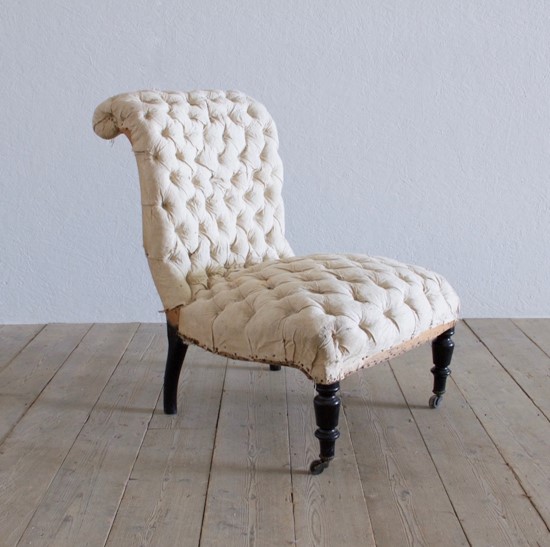 A buttoned slipper chair
