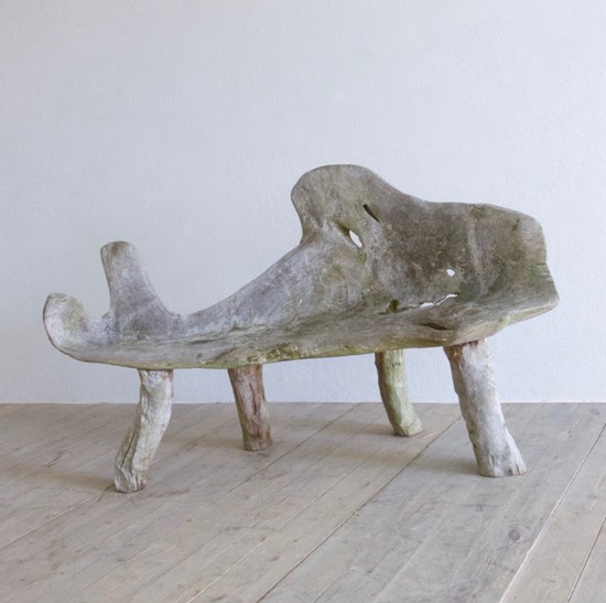 A sculptural teak bench