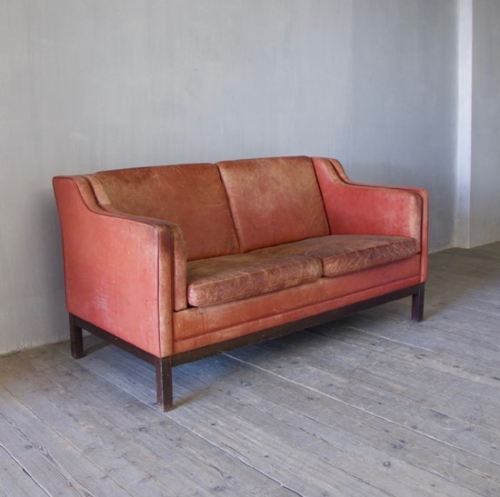 A mid-century red leather sofa