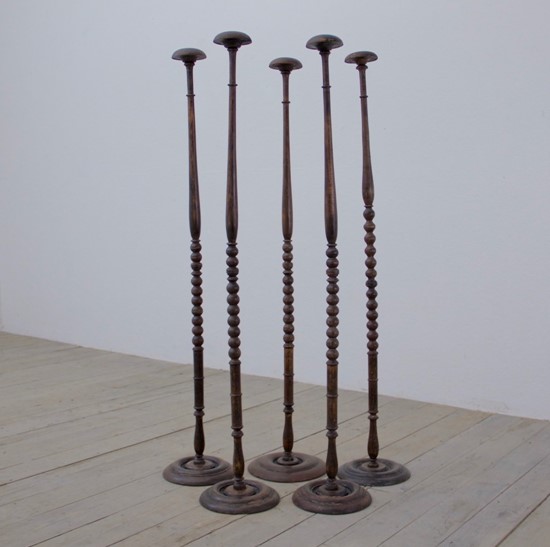 A collection of 5 ebonised hat stands