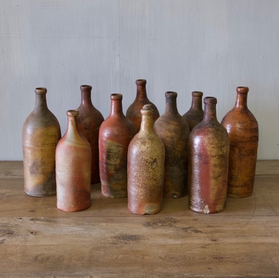 A set of ten clay bottles