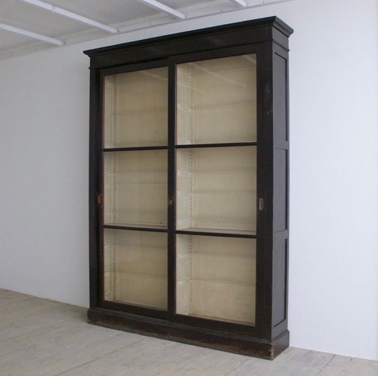 An ebonised sliding door cabinet