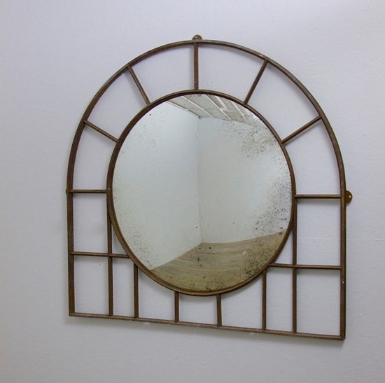 A large C19th wrought iron convex mirror