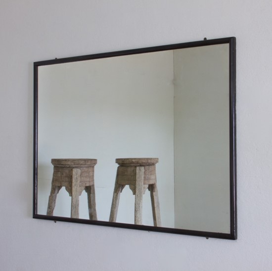 A large ebonised shop mirror