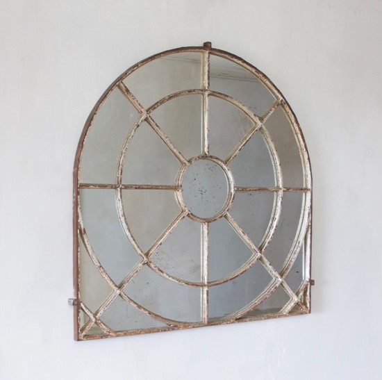 An unusual overmantle shaped cast iron window mirror