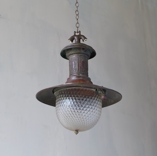 A rare copper station light with quilted glass shade