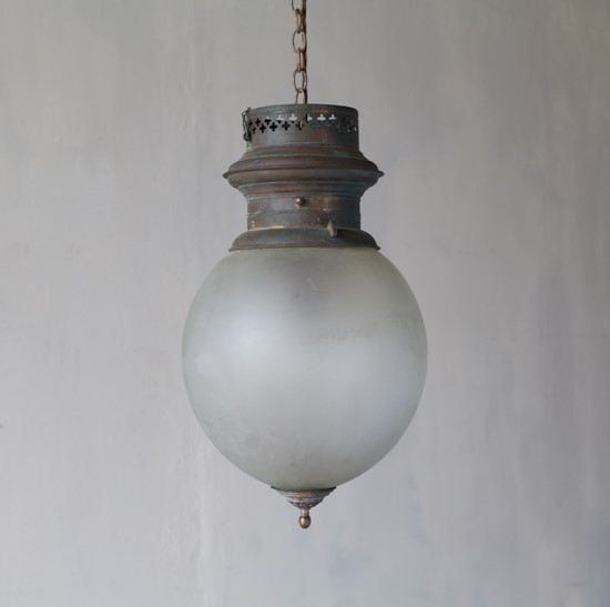 A large glass globe pendant light