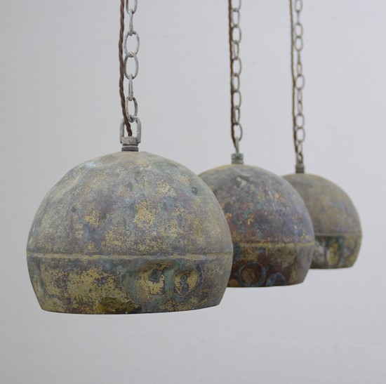 A set of three copper pendant lights