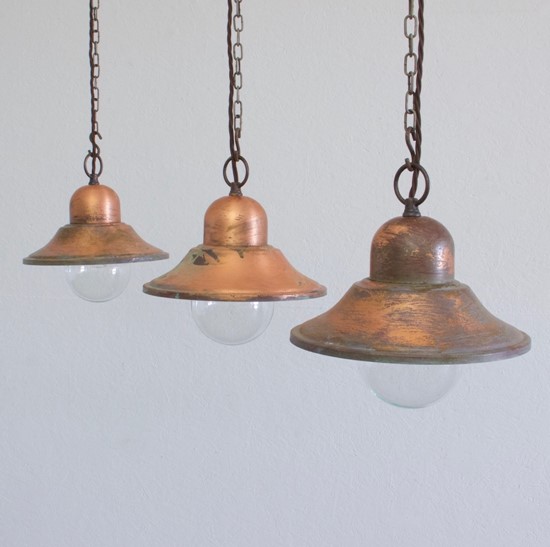 A set of 3 copper pendant lights