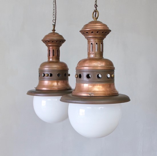 A pair of large copper pendants