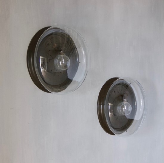 A large pair of glass wall lights