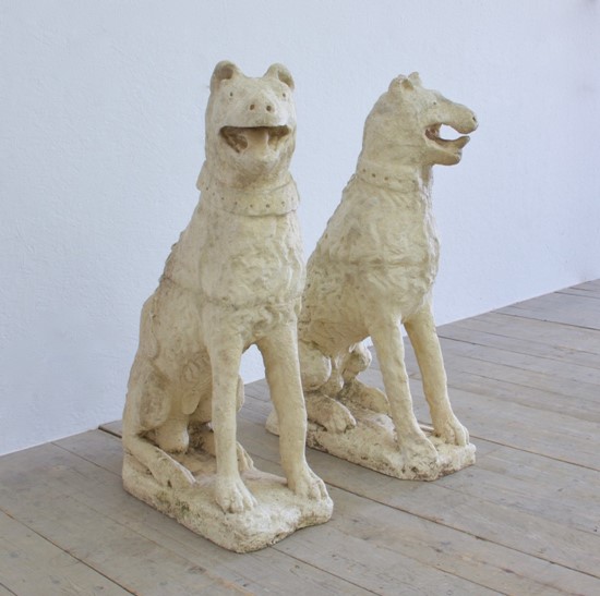 A pair of cast stone dogs